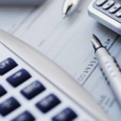 Close-up of a pen and computer mouse with a calculator